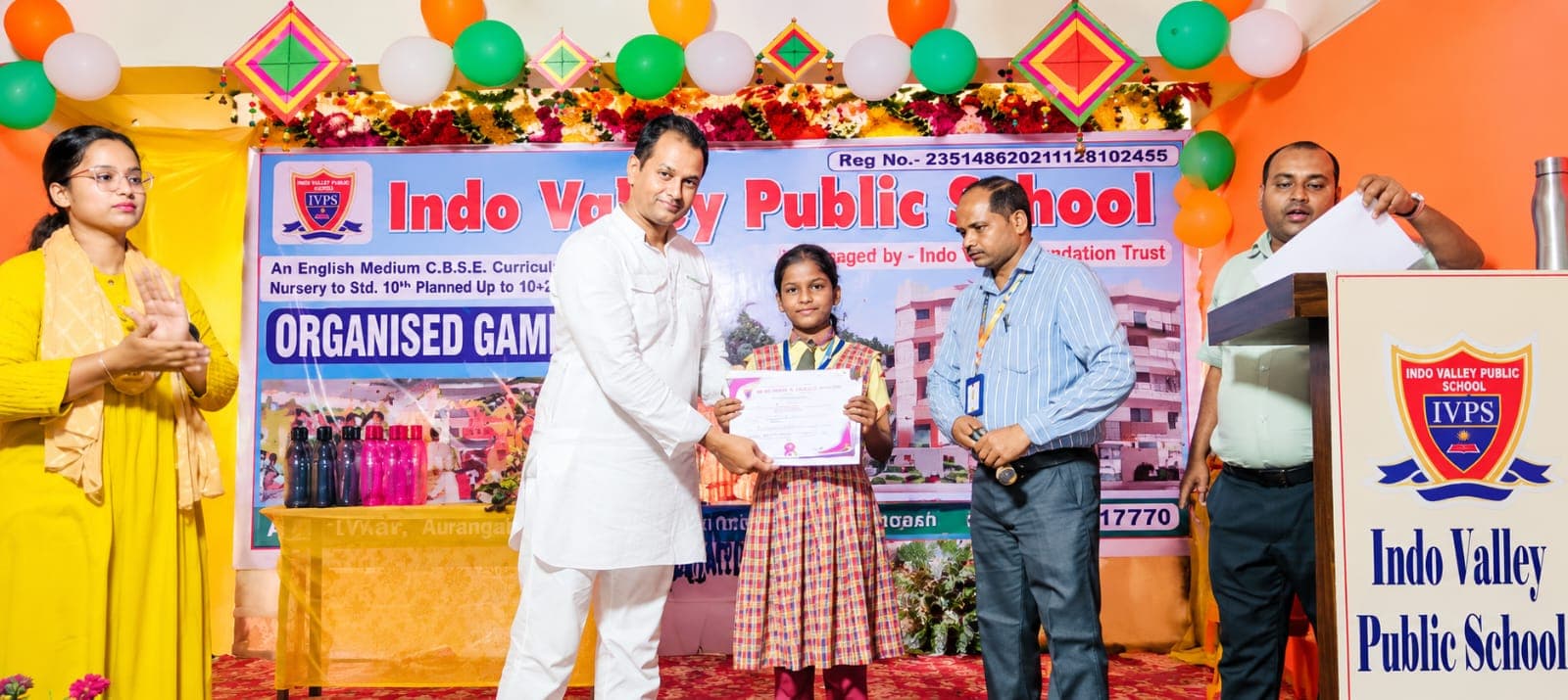A student receiving a prize at the GK quiz competition